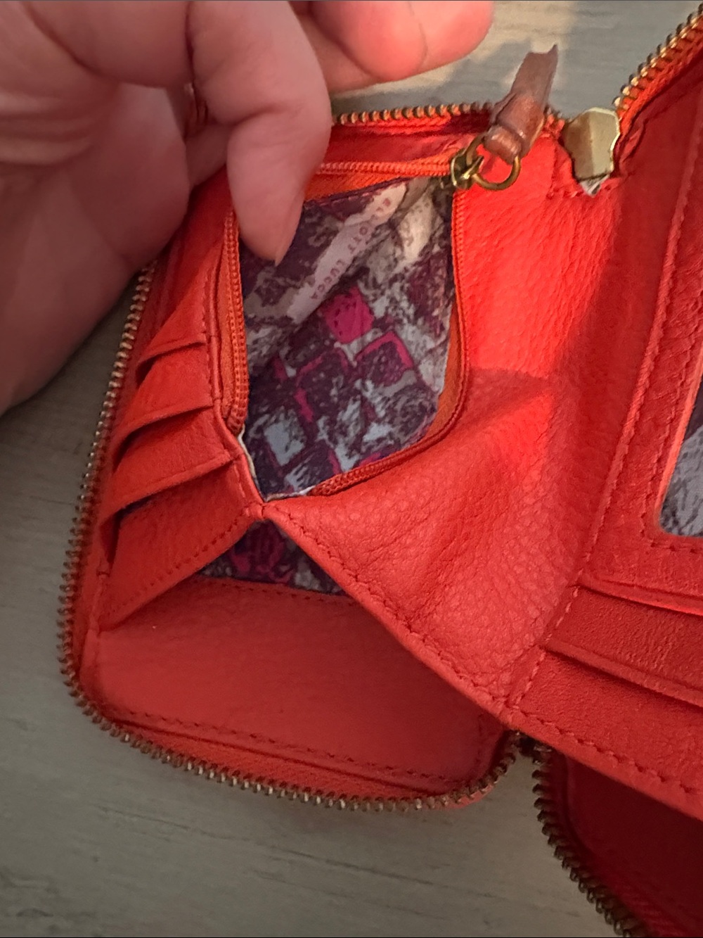 orange leather Elliott Lucca wristlet features a hand-painted peacock feather - Picture 7 of 8